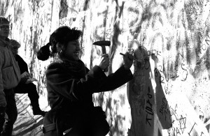 Charlene Li chisels at the Berlin Wall, November 11, 1989